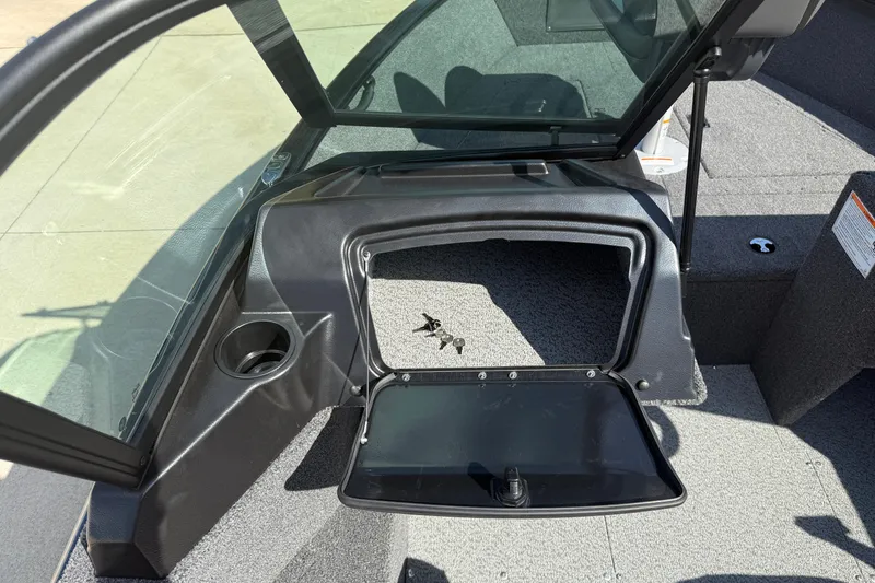 Slide: The Image of 2026 Lund 1650 Rebel XL Sport boat interior with storage compartment open. - 19