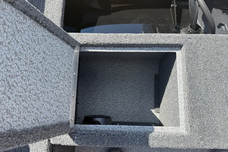 Slide: The Image of 2026 Lund 1650 Rebel XL Sport boat interior with storage compartments and carpeted flooring. - 22