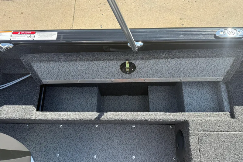 Slide: The Image of Warning and capacity labels on 2026 Lund 1650 Rebel XL Sport boat interior. - 23