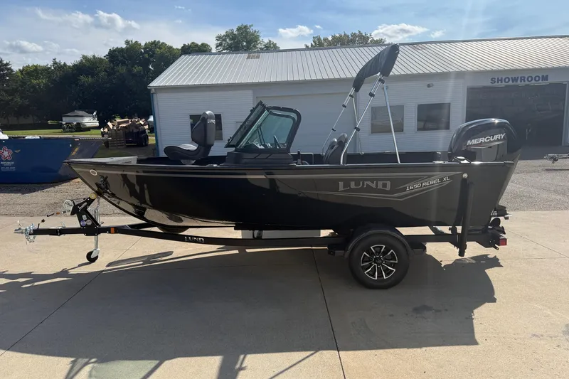 Slide: The Image of 2026 Lund 1650 Rebel XL Sport boat with Mercury engine on a trailer. - 3