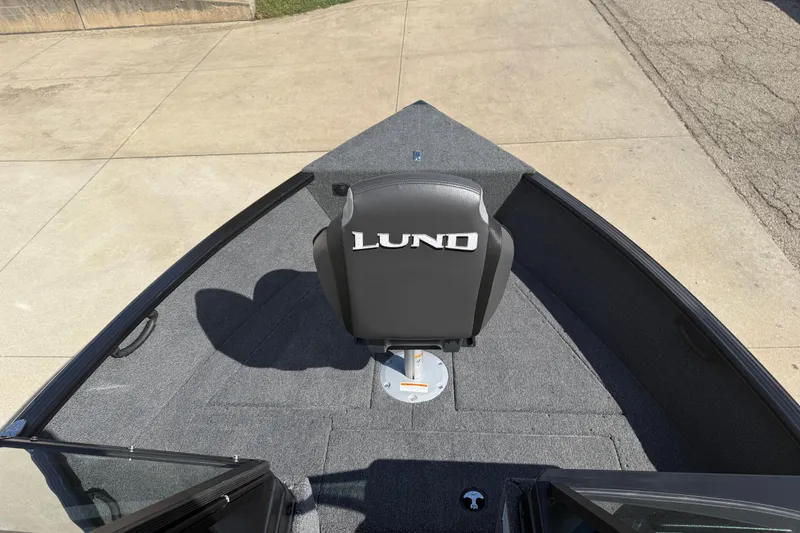 Slide: The Image of 2026 Lund 1650 Rebel XL Sport boat interior with storage compartment and fishing net. - 8