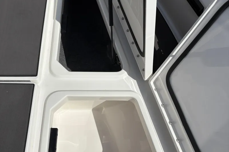 Slide: The Image of Open storage compartments on a 2026 Lund 185 Impact GL boat deck. - 12