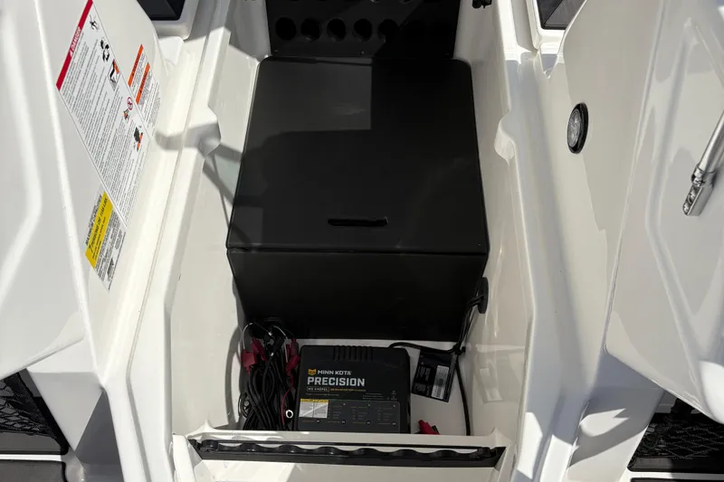 Slide: The Image of 2026 Lund 185 Impact GL boat storage compartment with Minn Kota Precision charger. - 14