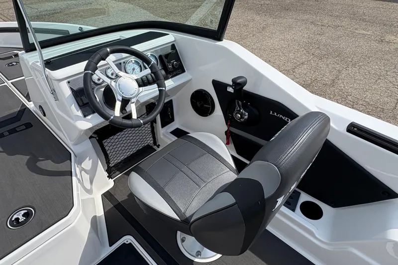 Slide: The Image of 2026 Lund 185 Impact GL boat interior with steering wheel and seat. - 17