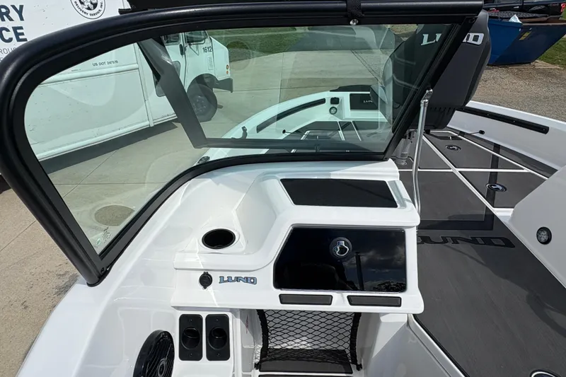 Slide: The Image of 2026 Lund 185 Impact GL boat interior with modern dashboard and seating. - 19