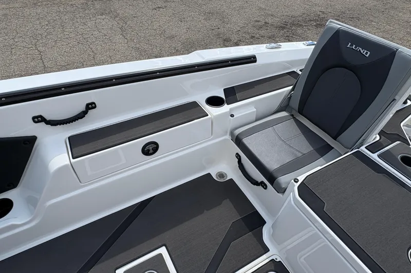 Slide: The Image of 2026 Lund 185 Impact GL boat interior with gray seating and storage compartments. - 23