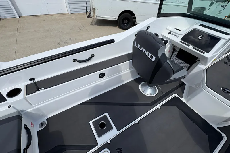 Slide: The Image of 2026 Lund 185 Impact GL boat interior with sleek seating and modern dashboard design. - 24