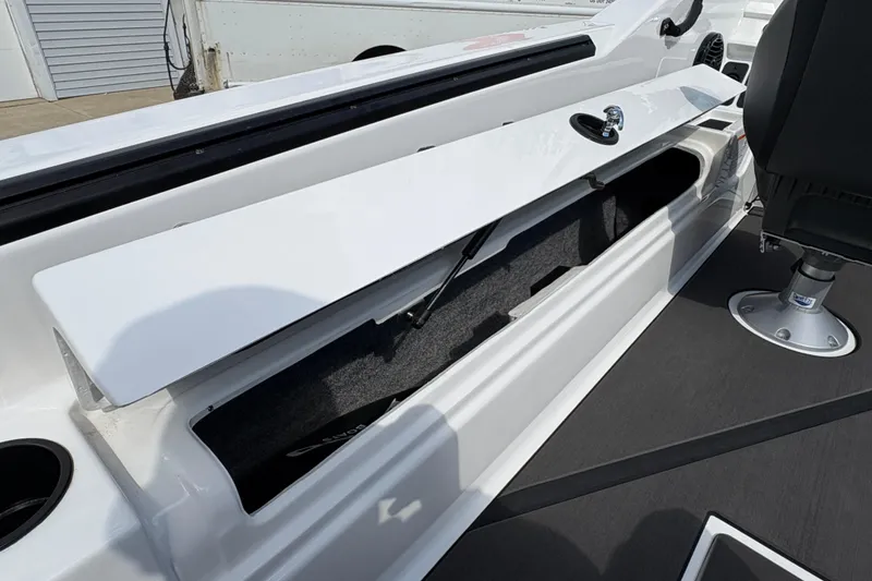 Slide: The Image of 2026 Lund 185 Impact GL boat interior storage compartment with open lid and seating. - 25