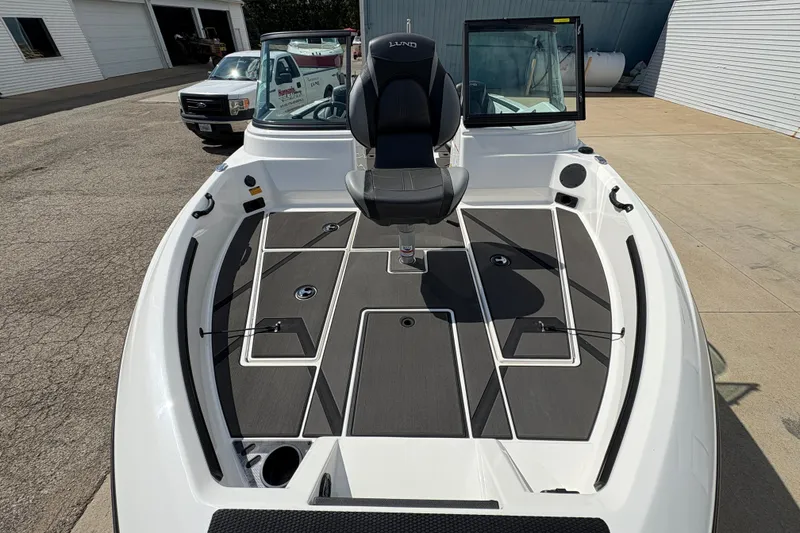 Slide: The Image of 2026 Lund 185 Impact GL boat with sleek deck design and comfortable seating. - 8