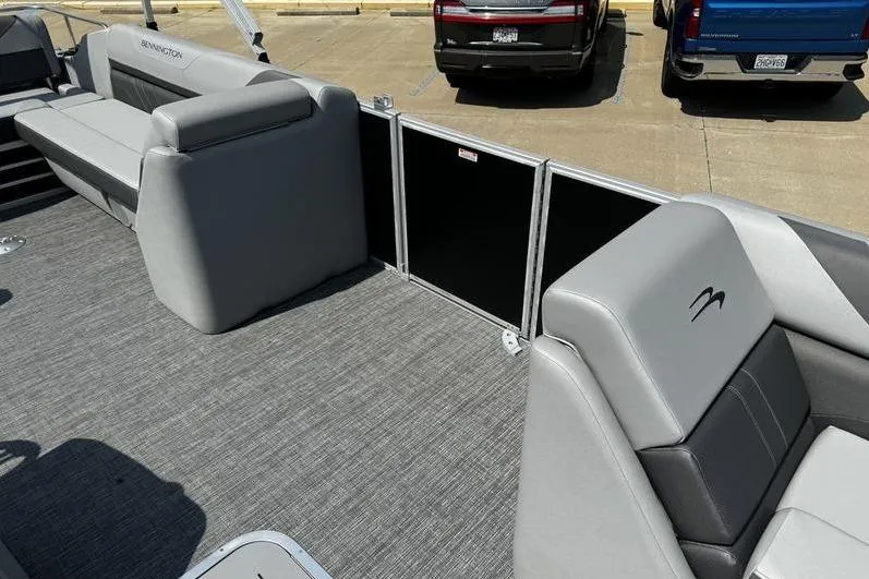 Slide: The Image of 2025 Bennington 25 SXSB pontoon boat interior with gray seating and carpeted flooring. - 12