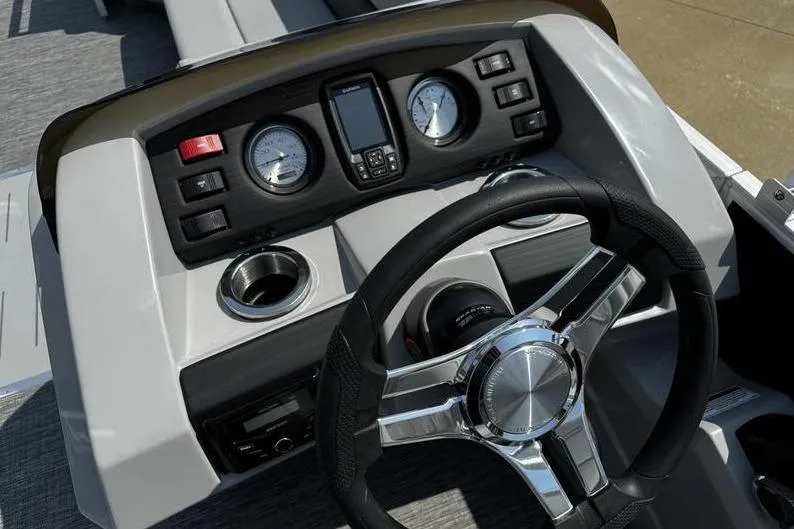 Slide: The Image of 2025 Bennington 25 SXSB boat dashboard with steering wheel and gauges. - 16