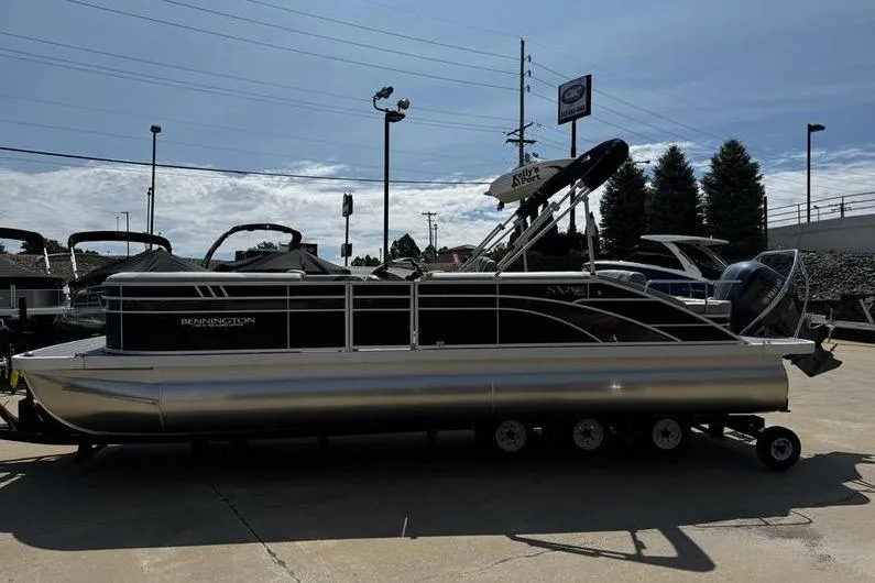 Slide: The Image of 2025 Bennington 25 SXSB pontoon boat on trailer in outdoor dealership lot. - 5
