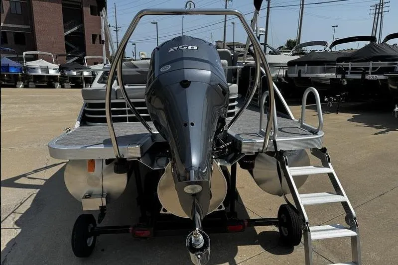Slide: The Image of 2025 Bennington 25 SXSB pontoon boat with powerful 250 engine, docked outdoors. - 7