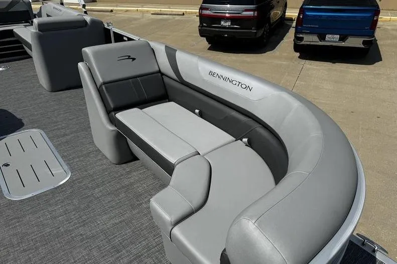 Slide: The Image of 2025 Bennington 25 SXSB boat with luxurious gray seating and sleek design. - 9