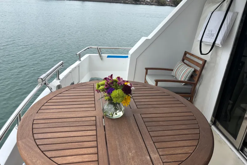 Slide: The Image of Wooden deck with table and flowers on 1986 Maiora Phantom yacht. - 10