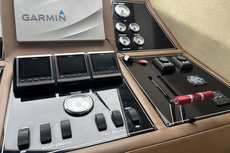 Slide: The Image of Control panel of a 1986 Maiora Phantom yacht featuring Garmin navigation equipment. - 12