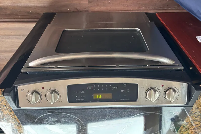 Slide: The Image of Luxurious kitchen interior of 1986 Maiora Phantom yacht with granite countertops and stainless steel appliances. - 15