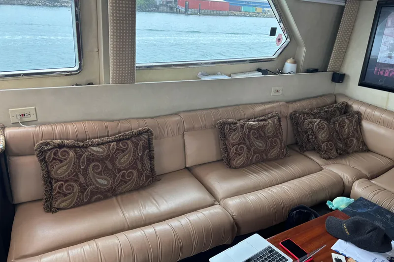 Slide: The Image of Luxurious interior of 1986 Maiora Phantom yacht with plush seating and decorative pillows. - 19