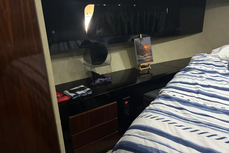 Slide: The Image of Cozy cabin interior of 1986 Maiora Phantom yacht with striped bedding and sleek furnishings. - 22