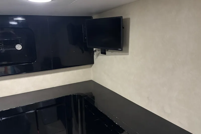 Slide: The Image of Interior of a 1986 Maiora Phantom yacht with sleek black and beige design. - 26