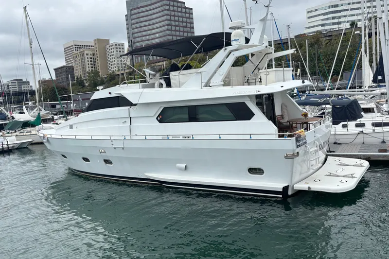 Slide: The Image of 1986 Maiora Phantom yacht docked in a marina, surrounded by other boats. - 3