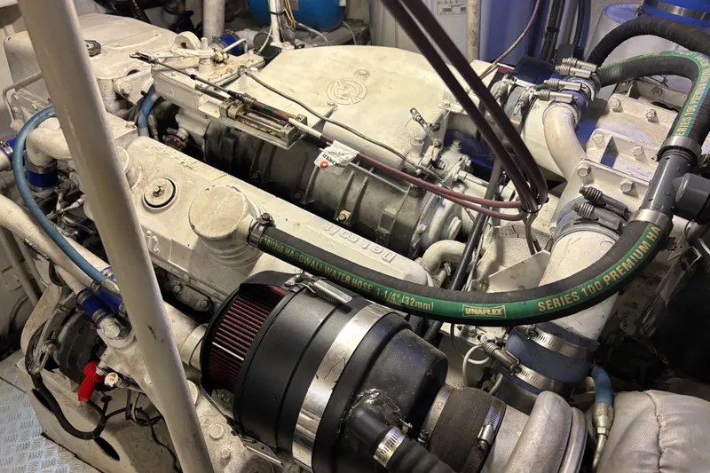 Slide: The Image of Engine of a 1986 Maiora Phantom yacht, featuring hoses and mechanical components. - 33