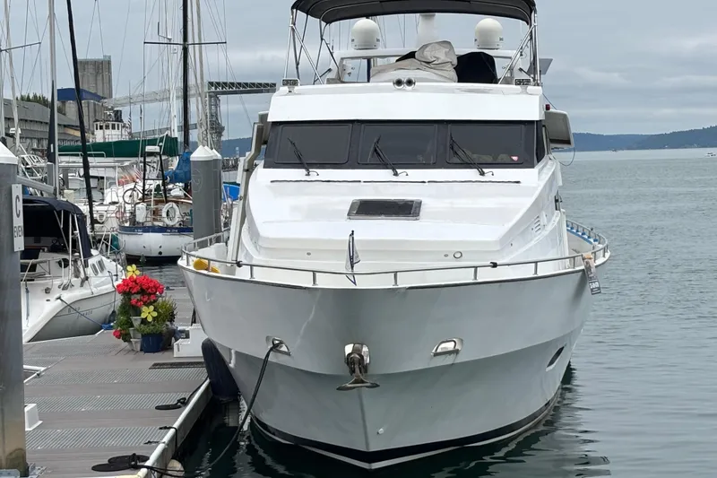Slide: The Image of 1986 Maiora Phantom yacht docked at marina, surrounded by other boats and flowers. - 4