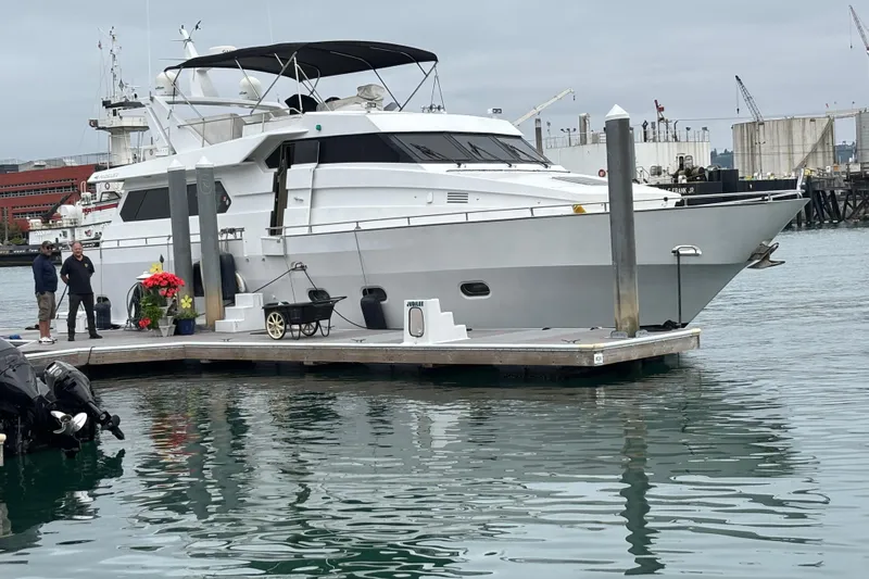 Slide: The Image of Luxury 1986 Maiora Phantom yacht docked at marina with people nearby. - 6