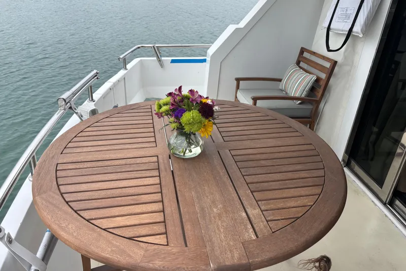 Slide: The Image of Wooden table with flowers on a 1986 Maiora Phantom yacht deck. - 9