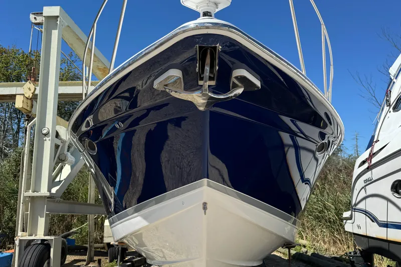 Slide: The Image of 2006 Formula 40 Performance Cruiser boat on dry dock, front view, blue hull. - 10