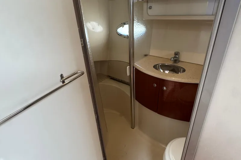 Slide: The Image of 2006 Formula 40 Performance Cruiser bathroom with sink, toilet, and storage cabinet. - 13