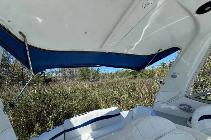 Slide: The Image of 2006 Formula 40 Performance Cruiser interior with blue canopy, surrounded by lush greenery. - 14