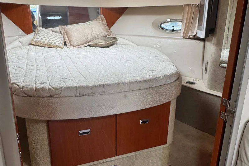 Slide: The Image of Cozy bedroom in 2006 Formula 40 Performance Cruiser with plush bedding and wooden accents. - 21