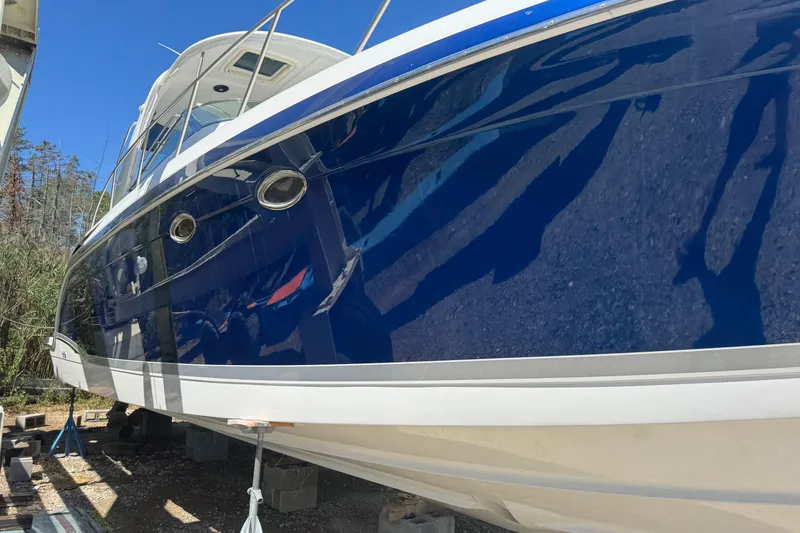 Slide: The Image of 2006 Formula 40 Performance Cruiser with sleek blue hull, docked outdoors. - 5