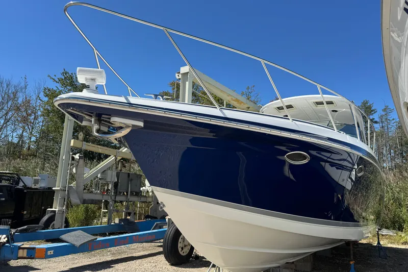 Slide: The Image of 2006 Formula 40 Performance Cruiser on trailer, blue hull, outdoor setting. - 7