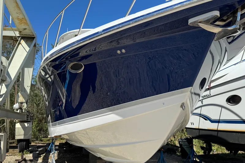 Slide: The Image of 2006 Formula 40 Performance Cruiser boat on dry dock, blue and white hull. - 9