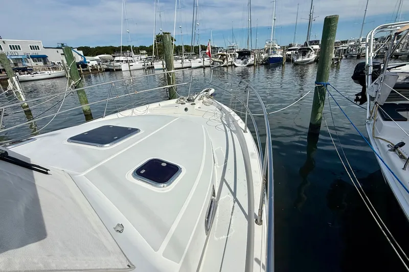 Slide: The Image of 2001 Sabre Sabreline 34 yacht docked at a marina, surrounded by other boats. - 10