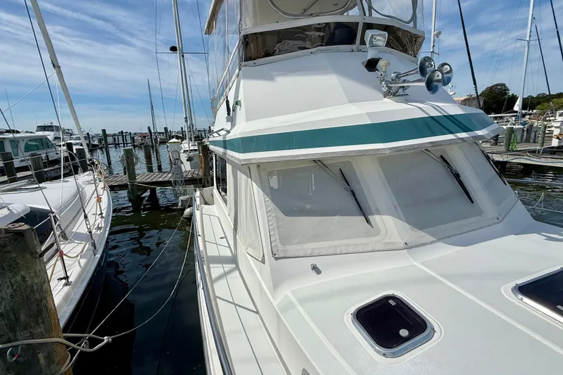 Slide: The Image of 2001 Sabre Sabreline 34 yacht docked at marina under clear blue sky. - 12