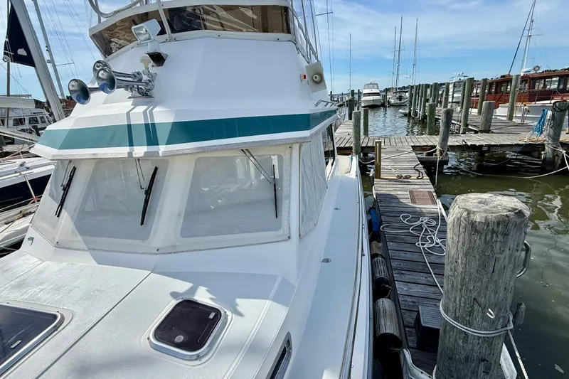 Slide: The Image of 2001 Sabre Sabreline 34 docked at marina, showcasing sleek design and nautical features. - 13