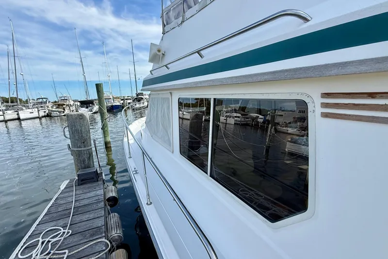 Slide: The Image of 2001 Sabre Sabreline 34 yacht docked at marina, reflecting boats and clear sky. - 15