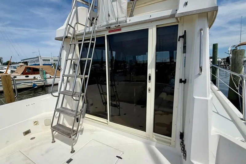 Slide: The Image of 2001 Sabre Sabreline 34 yacht with ladder and sliding glass doors at marina. - 17