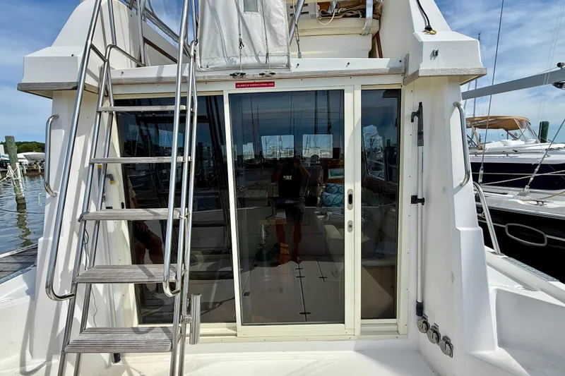 Slide: The Image of 2001 Sabre Sabreline 34 yacht with sliding glass doors and exterior ladder. - 19