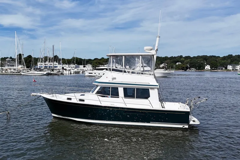 Slide: The Image of 2001 Sabre Sabreline 34 yacht docked in a scenic marina setting. - 2