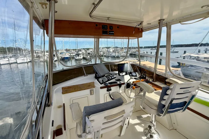 Slide: The Image of 2001 Sabre Sabreline 34 yacht cockpit with marina view, featuring navigation equipment and seating. - 20