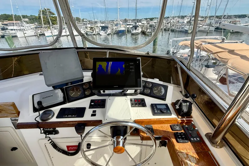 Slide: The Image of Helm of 2001 Sabreline 34 boat with navigation equipment and marina view. - 22
