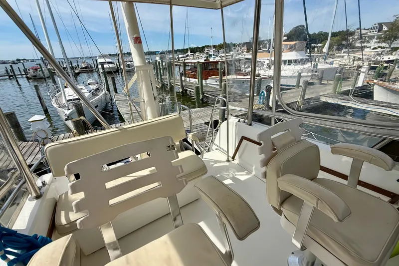 Slide: The Image of 2001 Sabre Sabreline 34 yacht interior with marina view, featuring comfortable seating and clear windows. - 24