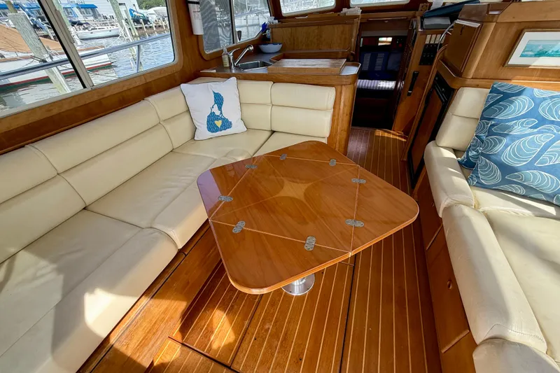 Slide: The Image of Luxurious interior of 2001 Sabreline 34 yacht with plush seating and elegant wooden table. - 26