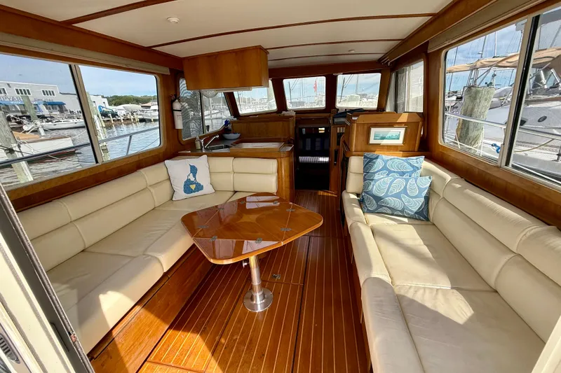 Slide: The Image of Interior of 2001 Sabre Sabreline 34 yacht with beige seating and wooden table. - 27