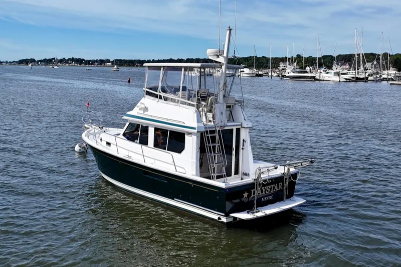 Slide: The Image of 2001 Sabre Sabreline 34 boat on calm water near marina. - 3