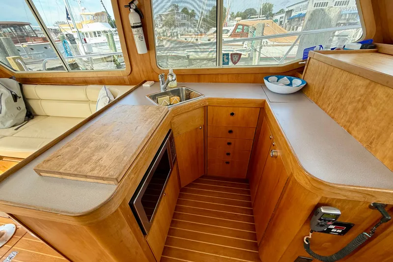Slide: The Image of Interior of 2001 Sabreline 34 yacht with wooden cabinetry and compact kitchen area. - 30